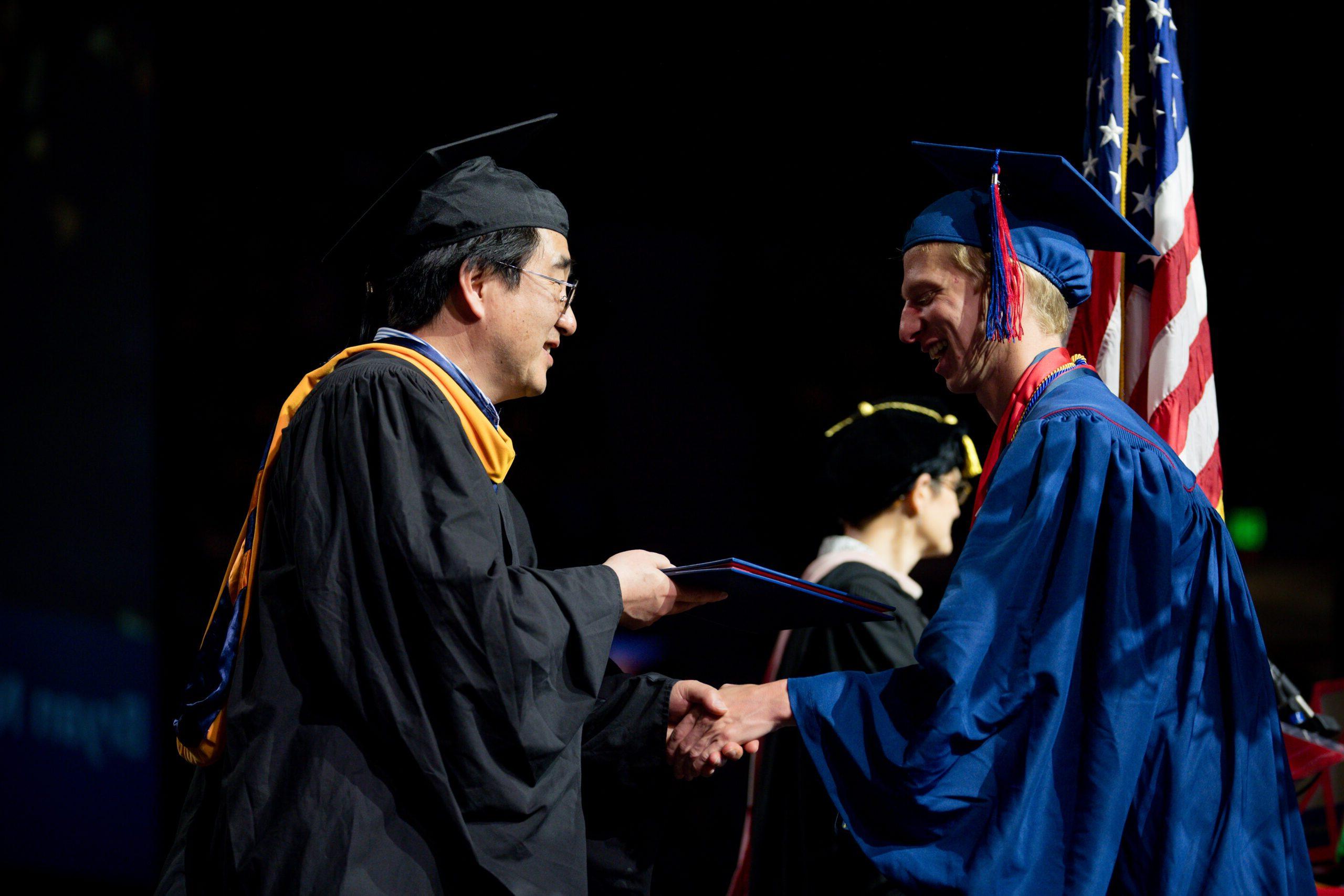 Industrial design chair Dr. Ted Shin with student at the Morning Ceremony.